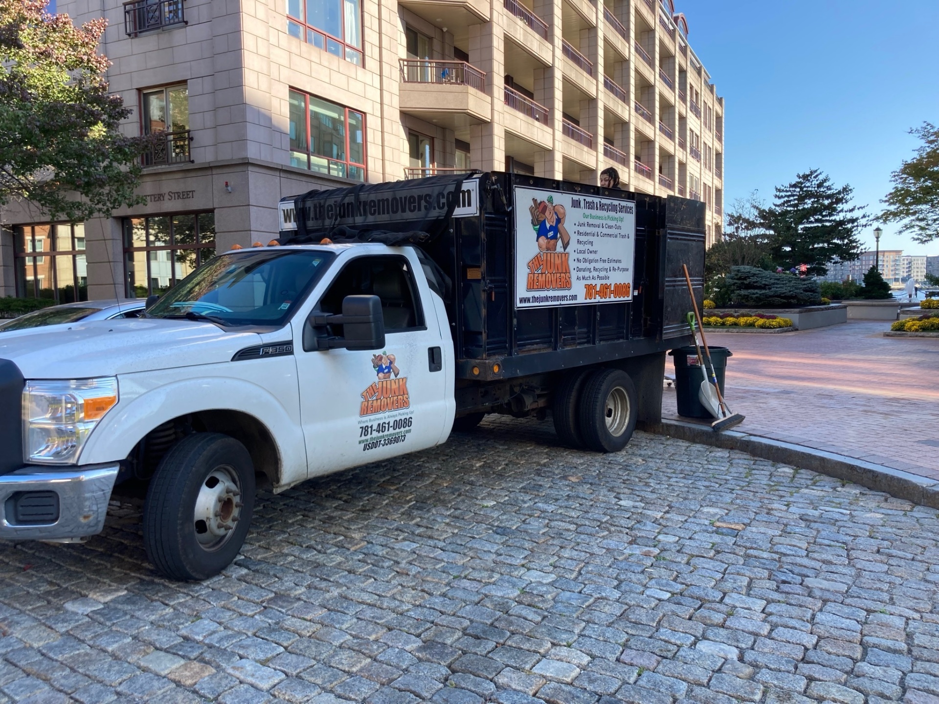 The Junk Removers truck on a Boston waterfront job
